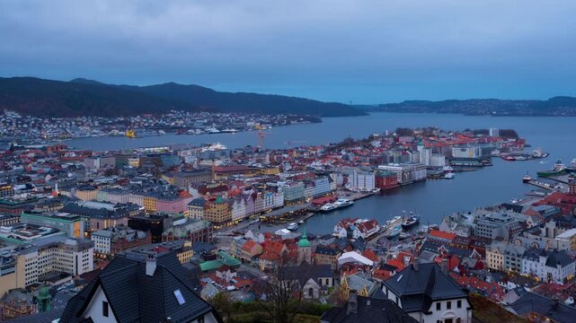 Bergen, Norway. Aerial view of Bergen, Norway at night. Cloudy sunset sky over the city with illuminated roads and car traffic. Time-lapse of Bryggen
