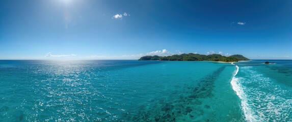 Panoramic scene of a tiny bay showcasing turquoise waters and a bright blue sky