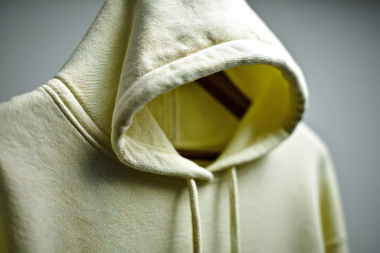 Hoodie on hanger flat lay with soft octabox lighting, cotton texture and warm Kodak Portra 400 style &ndash; product mockup