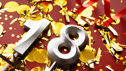 Number 18 celebration birthday digit on Red festive with confetti background. eighteen year...