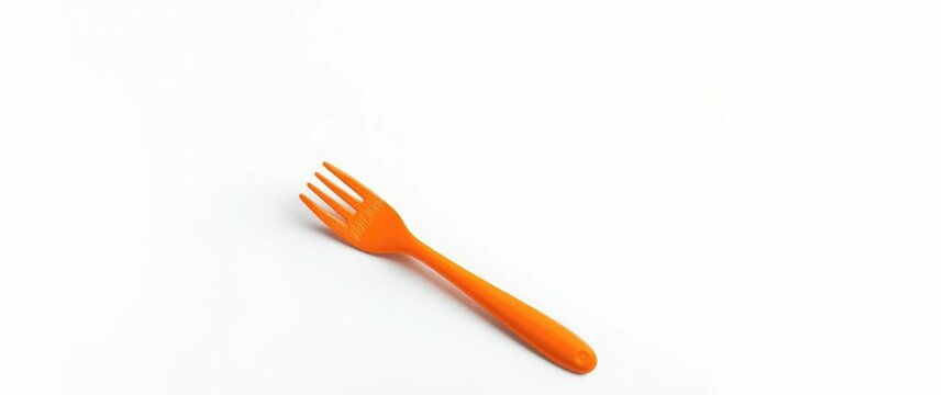 Broken orange plastic fork isolated on white surface with empty ad space