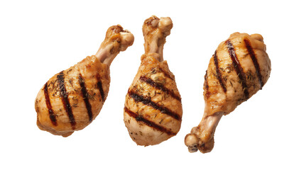 Three succulent golden brown grilled chicken drumsticks featuring distinct char marks and savory herbs for a meal, isolated on transparent background