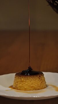 Caramel sauce pouring over homemade egg flan