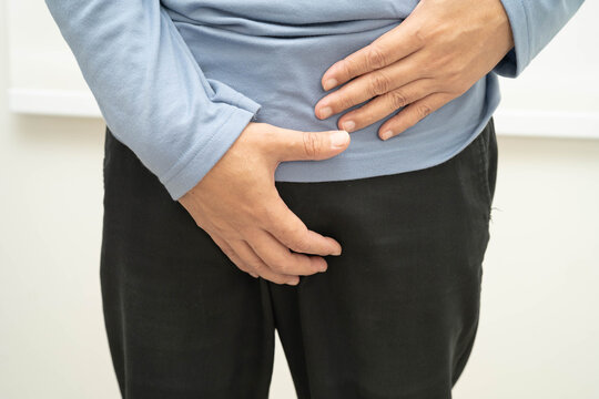 Hernia, Asian man stomach ache, abdominal pain and urology problem health.