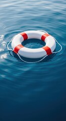 Naklejka premium A bright red and white safety ring floating calmly upon the deep blue water surface, symbolizing essential maritime preparedness and emergency rescue equipment, security, flotation, emergency