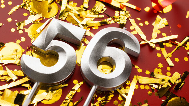 Number 56 celebration birthday digit on Red festive with confetti background. fifty-six year birthday. concept of birthday, anniversary and date.
