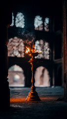 Antique Brass Samai Oil Lamp Glowing Softly in Traditional Moody Interior 2026