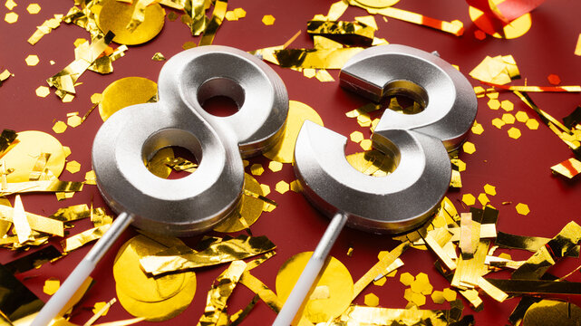 Number 83 celebration birthday digit on Red festive with confetti background. eighty-three year birthday. concept of birthday, anniversary and date.