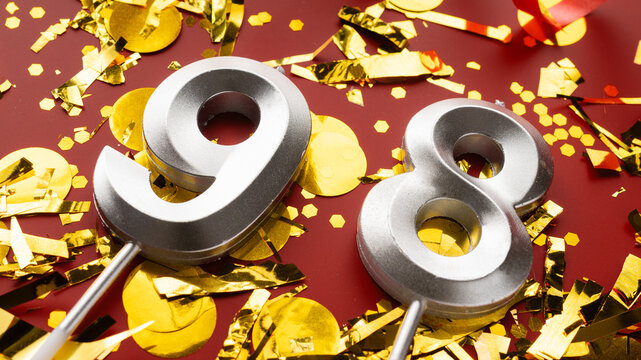 Number 98 celebration birthday digit on Red festive with confetti background. ninety-eight year birthday. concept of birthday, anniversary and date.