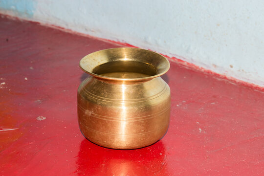traditional brass lota used for Hindu puja and worship rituals, symbolizing purity, devotion, and spiritual practice. Indian religious culture, sacred offerings, and traditional metal utensils 