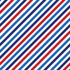 Obraz premium Striped diagonal lines seamless pattern in American flag colors red , navy blue and light blue. For fourth of July background, patriotic designs and wallpaper
