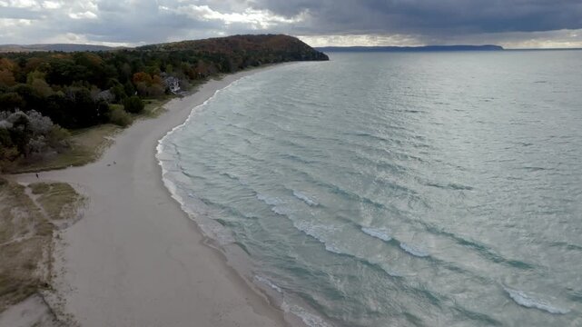 Lake Michigan shoreline in Leland, Michigan on a fall day with drone video moving in.