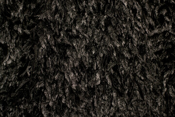 Fototapeta premium Close-up of black feather fabric. Fabric texture: feathers.