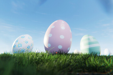 Close-up of decorative Easter eggs with pastel polka dots and floral patterns in green grass. Egg...