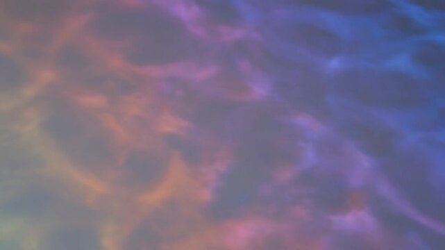 Abstract background texture displaying mesmerizing dynamic caustics patterns created by light refracting through gently moving water creating vibrant colorful waves of blue purple and orange hues.