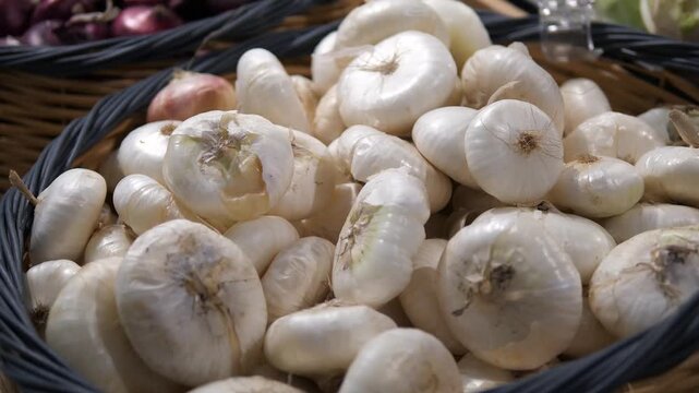 A bounty of fresh, aromatic garlic. This vibrant closeup showcases a plentiful heap of fresh white garlic bulbs in a rustic market basket, symbolizing abundance, natural produce, and authentic