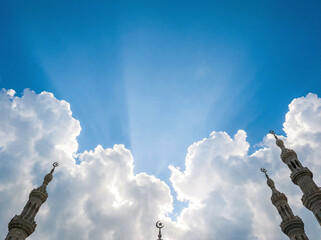 Islamic Crescent Moon in Blue Sky with White Clouds Ramadan Symbol Background