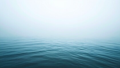 Fototapeta premium Calm Ocean Waters Under a Misty Sky - A Serene Landscape.