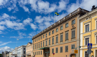 Neoclassical Architecture of Swedish Embassy in Helsinki Finland with Tan Facade and Swedish National Flag on Pohjoisesplanadi