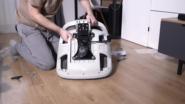 Installing the backrest of an office chair onto the seat during home assembly