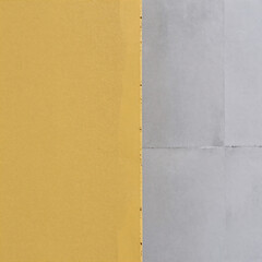 Fototapeta premium A yellow-textured rough cement wall with a seamless concrete background texture