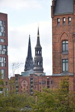 The famous churches "Michel" and "St. Katharinen" seen from the old warehouse city "Speicherstadt" in Hamburg, Germany