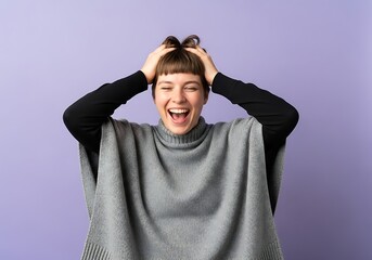 Young woman laughing with hands on her head against a lavender background