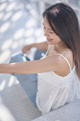 Young Woman Sitting on Stairs in Bright Natural Light
