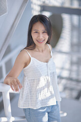Young Woman Smiling in Brightly Lit Modern Space with Natural Light