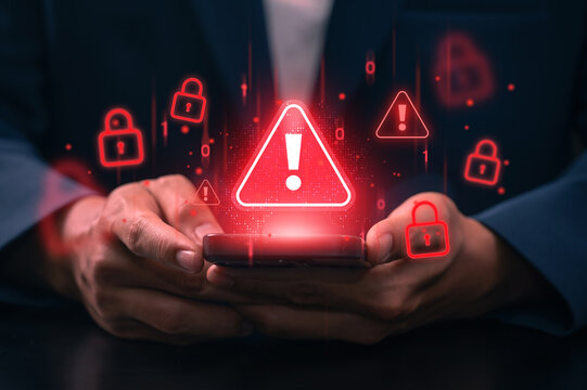 Cyberattack warning on mobile device. hands holding smartphone with red warning alert and cyber lock symbol. mobile security breach, data hacking threat, malware or phishing attack in digital device