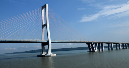 Fototapeta premium The architecture of the Suramadu Bridge, which spans the Madura Strait, Indonesia, was photographed from a ship about to pass beneath it.
