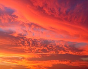 Obraz premium Fiery sky with vibrant, swirling clouds dyed orange, red and pink hues, signaling the end of the day or the beginning of a new one