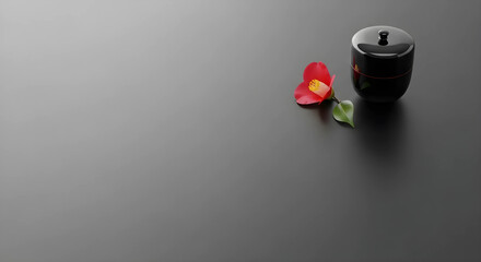 茶道具の棗と花びらのシックな和風背景。消炭色の背景に右上の格式高い装飾。高級旅館やブランド向けのデザイン余白。