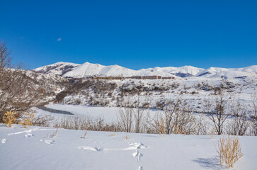 scenic view of Kechut reservoir, Aytsasar mountain and Jermuk ropeway from Arpa river valley (Vayots Dzor, Armenia)