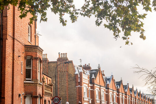 LONDON - Parsons Green New King's Road Victorian Houses &ndash; Autumn Foliage Framing Classic Fulham Red-Brick Terraces