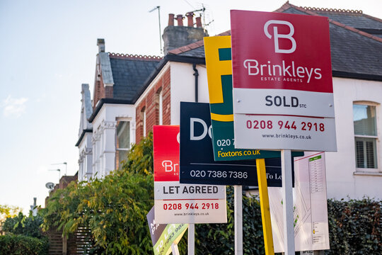 LONDON - SOUTH WEST LONDON RESIDENTIAL STREET &ndash; Cluster of estate agent boards with sold STC and let agreed signs outside Victorian