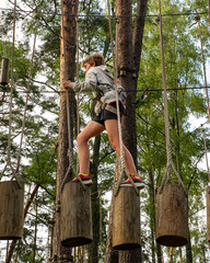 Active Boy Overcoming Rope Course Obstacles in Adventure Park