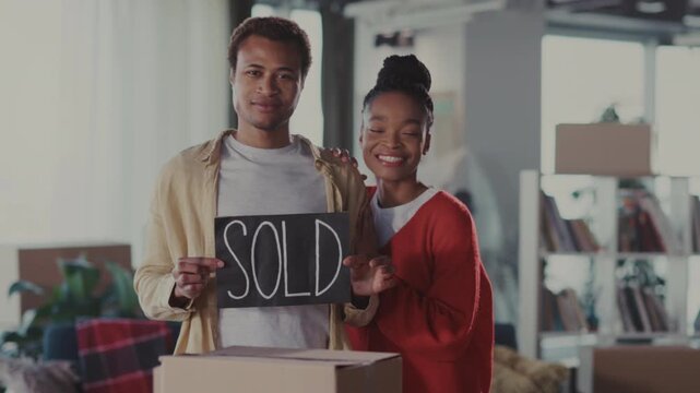 Joyful home milestone, Couple radiates happiness as they celebrate acquiring new home together in cozy surroundings