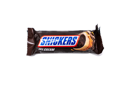 Germany Berlin January 30, 2026. Snickers ice cream bar in dark chocolate packaging isolated on white background. Professional studio photography highlighting packaging and brand visibility.