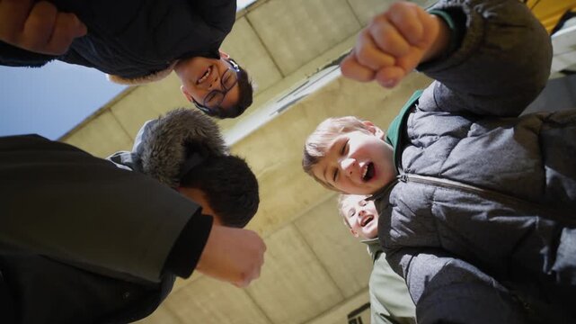 Group of bullying kids teasing victim low angle view