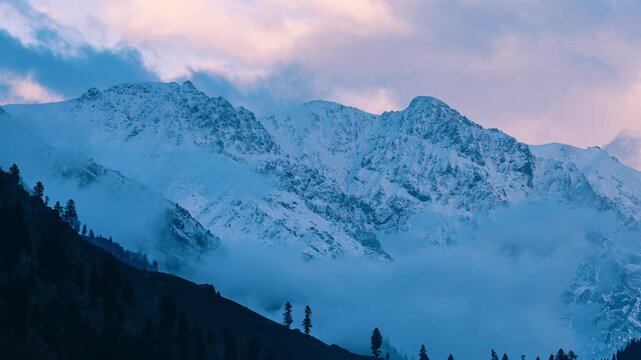 Cinematic Sunset to Blue Hour Transition of Cloud Movement in Himalayas, Beautiful Contrast of Warm Sunset Clouds and Cold Blue Mountain Mist, Wide Shot of Mist Spreading in Mountain Valley During Col