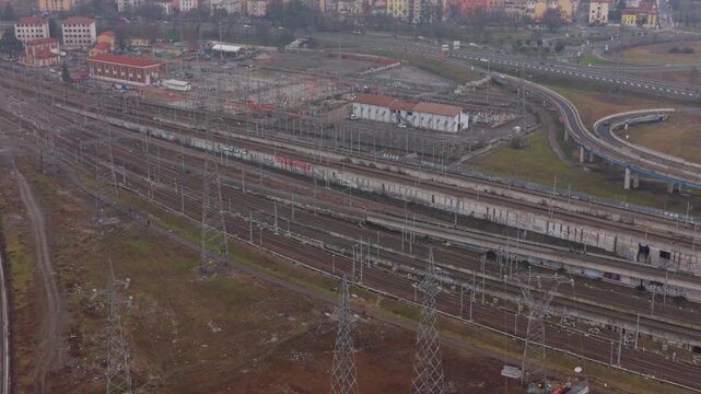 Urban Railway Junction: A comprehensive perspective showcases a sprawling railway junction in a bustling urban environment, encompassing a complex network of tracks, overhead lines.