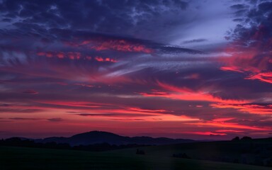 Fototapeta premium Vibrant sunset over rolling hills