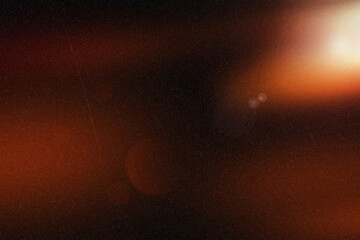 Warm light lens flare on a dark dusty background creating a mysterious glow effect