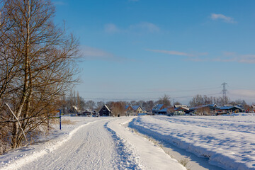 Nature path and houses covered with white snow in winter, 
Reigersbos is a residential area in Amsterdam-Zuidoost in the Gaasperdam district, The border between Gein and Abcoude, Utrecht, Netherlands.