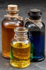 Vintage glass bottles with colorful liquids on dark background