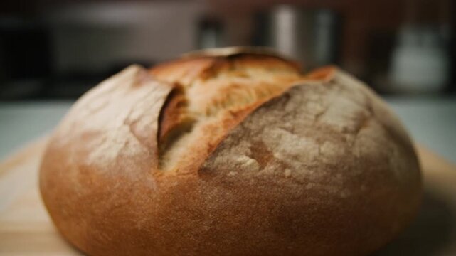 Freshly baked artisan bread, beautifully crafted and ready to enjoy. A close-up shot focuses on the bread's golden crust