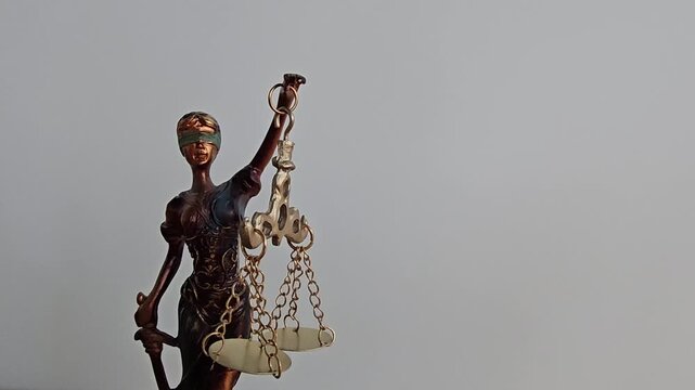Woman holding scales represents justice and law in a simple setting