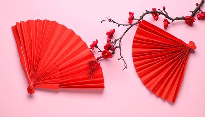 Red Paper Fans and Blossoms on Pink Background Symbolizing Elegance and Editorial Styling for Cultural and Seasonal Themes