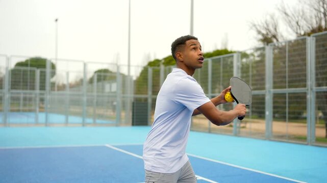 African american athlete serving ball playing pickleball game